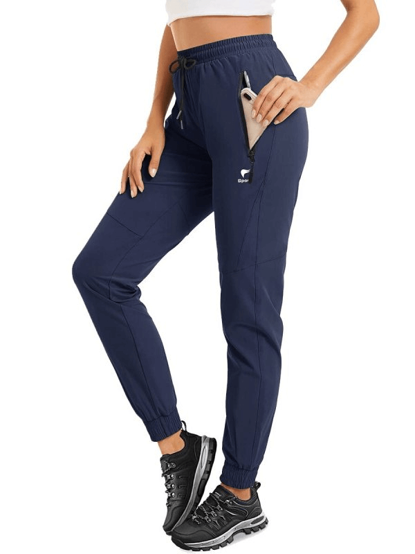 Travel Women's Quick-Drying Pants in navy with zippered pockets, worn by model, ideal for active comfort and stylish functionality.